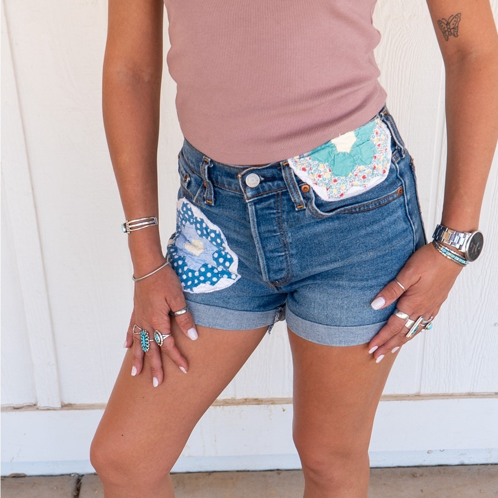 Levi’s denim shorts with vintage quilt pieces sewn on by me. Size 27.
